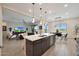 Open-concept kitchen with an island connects seamlessly to the living and dining areas, great for entertaining and Gathering gatherings at 14939 S 185Th Ave, Goodyear, AZ 85338