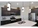 Spacious kitchen featuring an island, stainless appliances, and modern lighting, blending functionality with stylish design elements at 14939 S 185Th Ave, Goodyear, AZ 85338