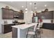 Modern kitchen features a spacious island, stainless steel appliances, and sleek cabinetry, perfect for culinary enthusiasts at 14939 S 185Th Ave, Goodyear, AZ 85338