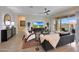 Bright living room features a ceiling fan, stylish furniture, and an open patio door with views of the outdoor living space at 14939 S 185Th Ave, Goodyear, AZ 85338