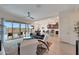 Inviting open-concept living room flowing into the dining area and kitchen with a view of the outdoor patio and pool at 14939 S 185Th Ave, Goodyear, AZ 85338