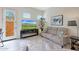 Comfortable living room showcasing a stylish sofa, modern entertainment center, and bright natural light at 14939 S 185Th Ave, Goodyear, AZ 85338