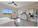 Bright main bedroom with a ceiling fan, scenic views, and stylish furniture, blending comfort and elegance seamlessly at 14939 S 185Th Ave, Goodyear, AZ 85338