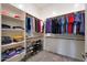 Walk-in closet with custom shelves, hanging rods, and storage for shoes and folded clothes at 14939 S 185Th Ave, Goodyear, AZ 85338