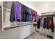 Spacious walk-in closet features hanging rods for clothing storage and shelves for folded items at 14939 S 185Th Ave, Goodyear, AZ 85338