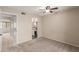 Cozy bedroom with neutral carpet and a ceiling fan, adjacent to the bathroom at 1545 E Sahuaro Dr # 12, Phoenix, AZ 85020