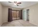 Bedroom featuring neutral carpet, large sliding glass doors, patio access, and closet with sliding doors at 1545 E Sahuaro Dr # 12, Phoenix, AZ 85020