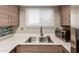Updated kitchen features stainless steel appliances, white countertops, stainless steel sink and wood cabinets at 1545 E Sahuaro Dr # 12, Phoenix, AZ 85020