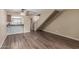 Open concept living room features wood-look flooring, breakfast bar, and stairway at 1545 E Sahuaro Dr # 12, Phoenix, AZ 85020