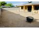 Wide backyard with a covered patio, fire pit, and plenty of space for outdoor activities at 16010 N 64Th Dr, Glendale, AZ 85306