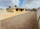 Large backyard features a well-maintained gravel area, covered patio, and ample space for outdoor activities at 16010 N 64Th Dr, Glendale, AZ 85306