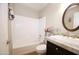 Well-lit bathroom featuring a shower-tub combo, wood floors, and a vanity sink at 16010 N 64Th Dr, Glendale, AZ 85306