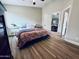 Spacious bedroom with bright walls, wood floors, and view to the home's dining room at 16010 N 64Th Dr, Glendale, AZ 85306
