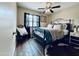 Bedroom with a ceiling fan, wood floors, area rug, and a metal frame bed at 16010 N 64Th Dr, Glendale, AZ 85306