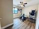 Exercise room with wood floors, bright walls, ceiling fan, and workout equipment at 16010 N 64Th Dr, Glendale, AZ 85306