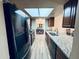 Well-lit kitchen featuring stainless steel appliances and beautiful granite countertops with dark wood cabinetry at 16010 N 64Th Dr, Glendale, AZ 85306