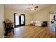 Bright living room featuring wood-look flooring and sliding glass doors at 16010 N 64Th Dr, Glendale, AZ 85306