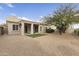 A low maintenance backyard with mature tree and large gravel ground cover at 16155 E Glenview Pl, Fountain Hills, AZ 85268