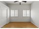 Empty bedroom with hardwood floors, shuttered windows, and a closet at 16155 E Glenview Pl, Fountain Hills, AZ 85268