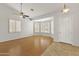 Bright living room with hardwood floors, shuttered windows, and a ceiling fan at 16155 E Glenview Pl, Fountain Hills, AZ 85268