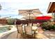 An outdoor patio with seating, lounge chairs, and a grill next to a private pool at 16857 E Deuce Ct, Fountain Hills, AZ 85268