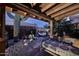 Relaxing backyard retreat featuring desert plants, decorative metalwork, and a daybed at 16857 E Deuce Ct, Fountain Hills, AZ 85268
