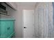 Bathroom featuring turquoise cabinet, shelving, and grey patterned shower curtain at 16857 E Deuce Ct, Fountain Hills, AZ 85268