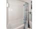 Clean white tub and shower combination with decorative curtain at 16857 E Deuce Ct, Fountain Hills, AZ 85268