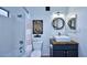 Updated bathroom with a tub, white tile, wooden vanity and modern fixtures at 16857 E Deuce Ct, Fountain Hills, AZ 85268