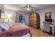 Cozy bedroom with a unique wardrobe, ceiling fan, and lots of natural light from the window at 16857 E Deuce Ct, Fountain Hills, AZ 85268