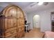 Bedroom featuring unique wooden wardrobe, desk, ceiling fan, and access to the bathroom at 16857 E Deuce Ct, Fountain Hills, AZ 85268