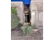 Close-up of the front entryway with well-maintained landscaping and a secure front door with multiple glass panes at 16857 E Deuce Ct, Fountain Hills, AZ 85268
