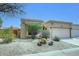 A charming home exterior with desert landscaping and a quaint, appealing design at 16857 E Deuce Ct, Fountain Hills, AZ 85268