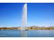 Scenic lake view features a tall fountain with mountains and homes in the background at 16857 E Deuce Ct, Fountain Hills, AZ 85268