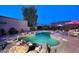 Backyard pool with rock waterfall feature and surrounding desert landscaping for a private oasis at 16857 E Deuce Ct, Fountain Hills, AZ 85268