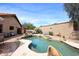 A stunning backyard featuring a sparkling pool, rock accents, and inviting lounge areas at 16857 E Deuce Ct, Fountain Hills, AZ 85268