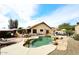 Beautiful pool with a baja step, rock waterfall, and multiple patio spaces for entertaining at 16857 E Deuce Ct, Fountain Hills, AZ 85268