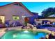 Backyard swimming pool with rock waterfall feature, desert landscaping and patio seating at 16857 E Deuce Ct, Fountain Hills, AZ 85268