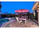 Backyard pool with outdoor dining, lounge chairs, and desert landscaping under a serene sky at 16857 E Deuce Ct, Fountain Hills, AZ 85268