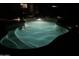 Tranquil, illuminated pool at night offers a serene escape, surrounded by rock accents and subtle landscaping lighting at 16857 E Deuce Ct, Fountain Hills, AZ 85268