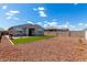 Spacious backyard with artificial turf and gravel, enclosed by block fencing for added privacy at 17454 W Red Fox Rd, Surprise, AZ 85387
