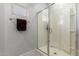 Bathroom shower with glass doors, white tile, and a towel bar at 17454 W Red Fox Rd, Surprise, AZ 85387