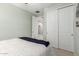 Bedroom with a queen size bed and sliding closet doors at 17454 W Red Fox Rd, Surprise, AZ 85387