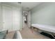 Bedroom with a massage table, a closet, and an en-suite bathroom at 17454 W Red Fox Rd, Surprise, AZ 85387