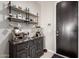 Charming coffee station with ample storage, decorative mugs, and a stylish espresso machine at 17454 W Red Fox Rd, Surprise, AZ 85387