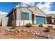 Beautiful home featuring desert landscaping, blue shutters, and a well-maintained exterior at 17454 W Red Fox Rd, Surprise, AZ 85387