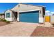 Single story home with a blue garage door and nicely manicured lawn at 17454 W Red Fox Rd, Surprise, AZ 85387