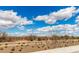 Scenic landscape view featuring a road, clear blue sky, and distant mountains and desert foliage at 17454 W Red Fox Rd, Surprise, AZ 85387