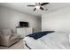 View of the Main Bedroom with a comfortable chair and a media center with a television at 17454 W Red Fox Rd, Surprise, AZ 85387