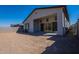 The house's backyard features a large patio area, a partial view of the house, and clear blue skies at 21430 W Meadowbrook Ave, Buckeye, AZ 85396